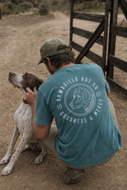 Man in the Bird Dog Tee with an English pointer on a ranch road