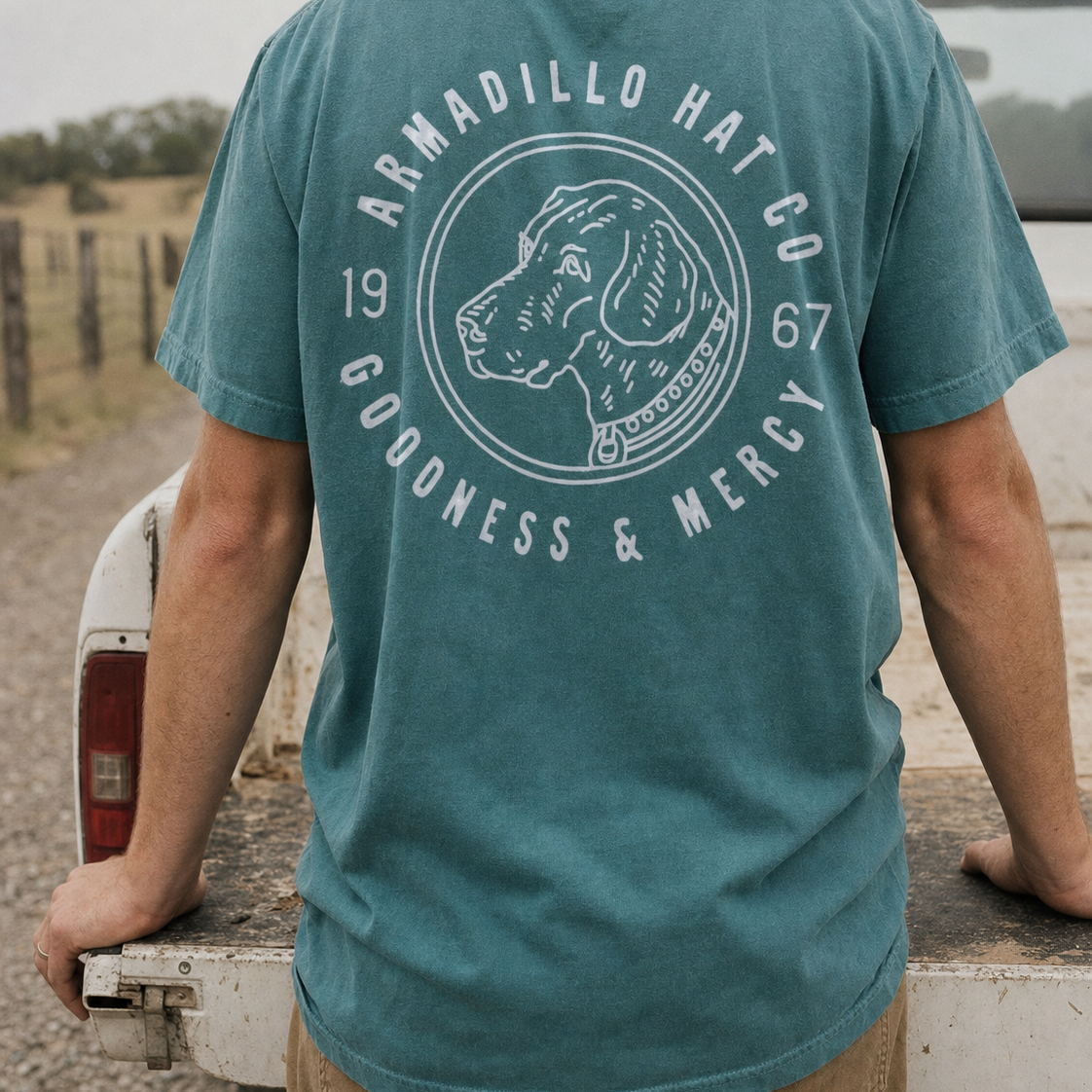 Bird Dog Tee back print in Blue Spruce at a truck tailgate