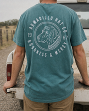 Bird Dog Tee back print in Blue Spruce at a truck tailgate